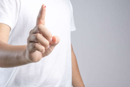 Hand with blood drop at finger from needle for sample testing on white background