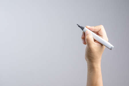 Hand holding gradient level adjustment permanent marker on white backgroundの写真素材