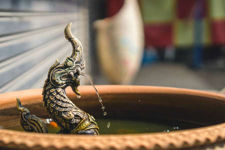 Common fountain sculpture of Naga of sacred dragon serpent in the pondの写真素材