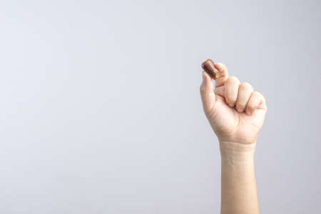 Hand holding dried date fruits isolated on white backgroundの写真素材