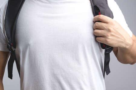 Hand holding bag backpack bag strap on white backgroundの写真素材