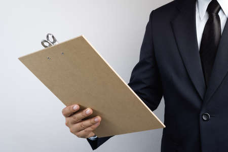 Business man hand holding wooden clipboard on white background
