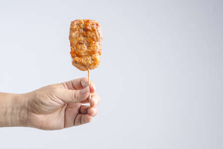 Grilled pork with sweet spicy sauce on Skewer as famous Thai traditional foodの写真素材