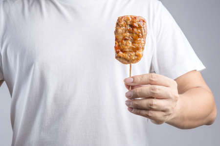 Grilled pork with sweet spicy sauce on Skewer as famous Thai traditional foodの写真素材