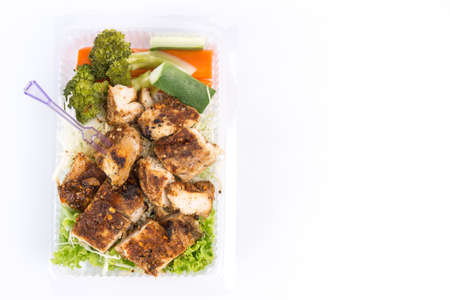 Grilled chicken breast with thai spicy sauce and vegetable on white backgroundの写真素材
