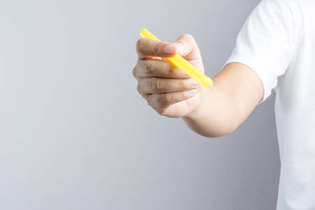 Hand holding a big or extra large drinking straw on white backgroundの写真素材