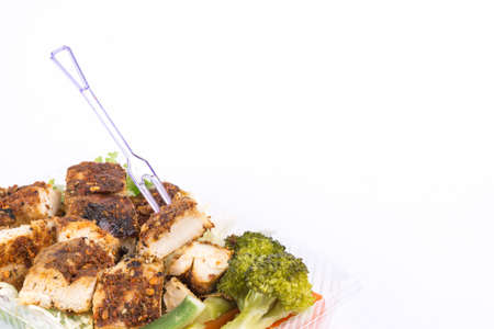 Grilled chicken breast with thai spicy sauce and vegetable on white backgroundの写真素材