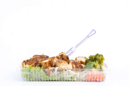 Grilled chicken breast with thai spicy sauce and vegetable on white backgroundの写真素材