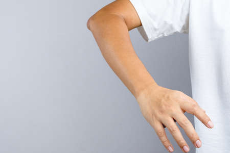 Hand with sun burn left the mark on wrist watch on white backgroundのeditorial素材