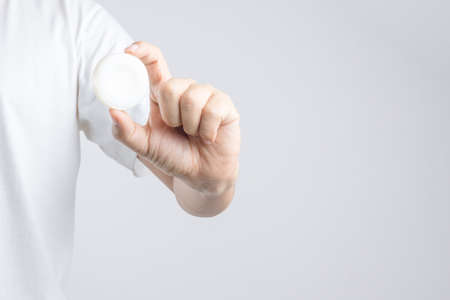 Hand holding round common hotel soap on white backgroundのeditorial素材