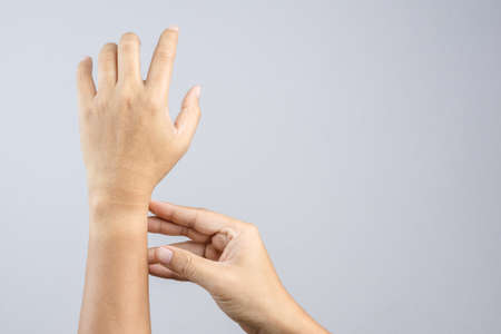 Hand with sun burn left the mark on wrist watch on white backgroundのeditorial素材