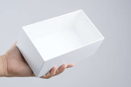 Hand holding blank white box give gift on white backgroundのeditorial素材