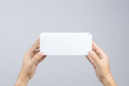 Hand holding blank white box give gift on white backgroundのeditorial素材