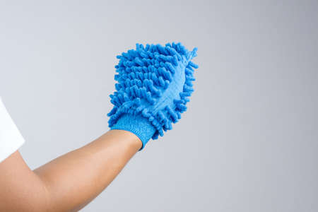 Hand wearing dust glove or double sided mitt microfiber car wash on white backgroundの写真素材