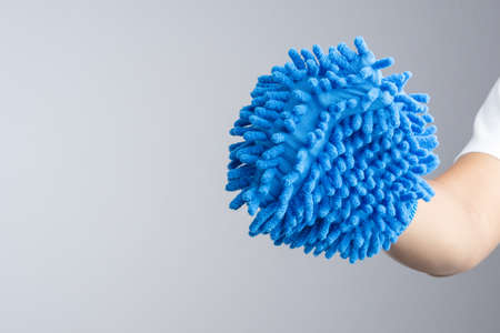 Hand wearing dust glove or double sided mitt microfiber car wash on white backgroundの写真素材