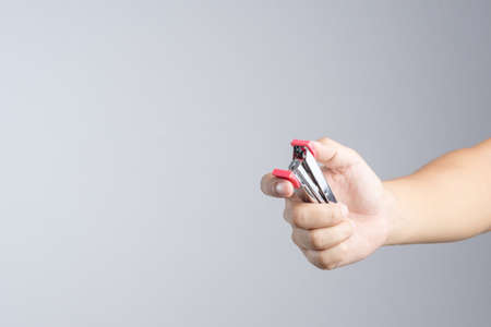 Hand holding stapler, an office supplies for  stapling pages of paper or similar material on white backgroundの写真素材