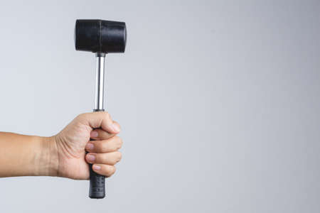 Rubber mallet or hammer with steel stick, mason tool for adjusting brick pavement or folding a metal sheet on white backgroundの写真素材