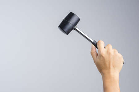 Rubber mallet or hammer with steel stick, mason tool for adjusting brick pavement or folding a metal sheet on white backgroundの写真素材