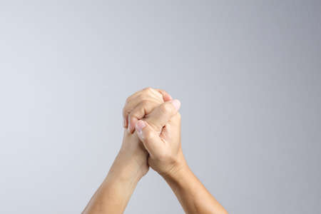 Hand with praying sign or gesture in christian religion on white backgroundの写真素材