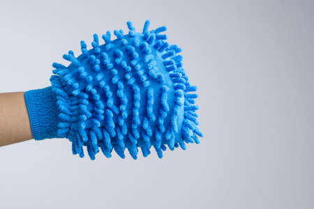 Hand wearing dust glove or double sided mitt microfiber car wash on white backgroundの写真素材