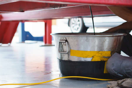Steel bucket use for store old engine or mechanic oil from a car for change at an auto shopの写真素材