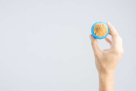 hand holding bamboo or wooden toothpick pack on white backgroundの写真素材