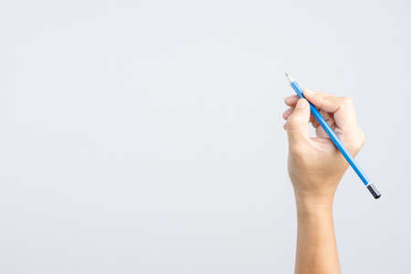 Hand holding 2B pencil with writing gesture on white backgroundの写真素材