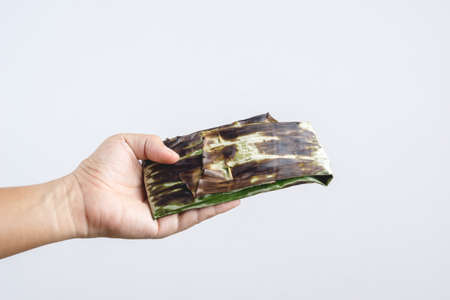 Food in grilled banana leave wrap, Thai and Asian traditional way of cooking