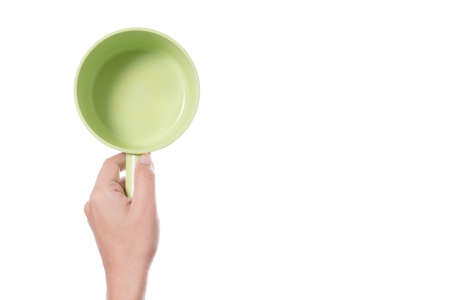 Hand holding plastic bath bowl for shower or watering on white backgroundの写真素材