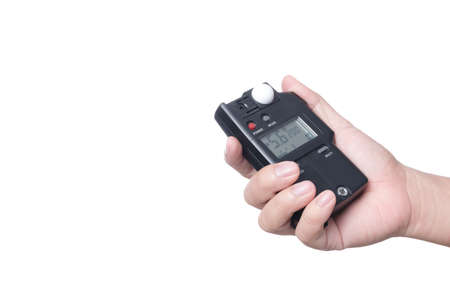 Hand holding light exposure meter, a photograph device for measuring illumination on white...