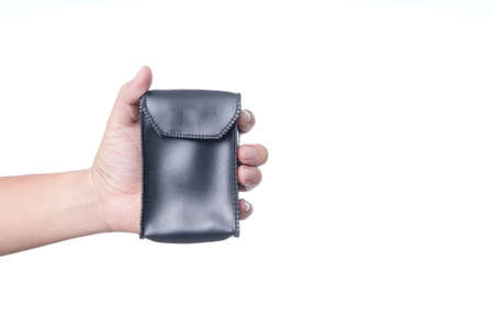 Hand holding leather pouch bag, a accessory equipment on white backgroundの写真素材