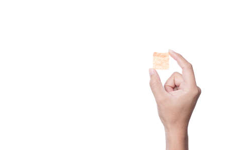 Hand holding dried pork snack, made of pure meat on white backgroundの写真素材