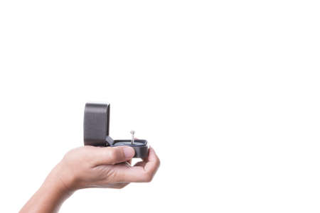 A man hand holding box with ring for marriage proposal on white background