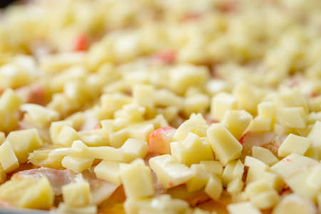 Fresh cheese crumbles over pasta before bake into a homemade pizza