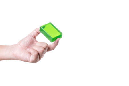 Hand holding green handmade soap bar made from herbal on white backgroundの写真素材