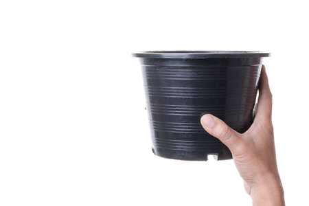 Hand holding recycle plastic plant pot on white backgroundの写真素材