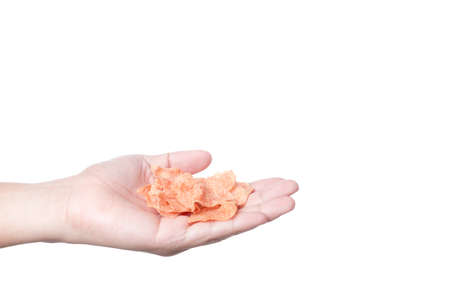 Hand holding dried pork snack, made of pure meat on white backgroundの写真素材