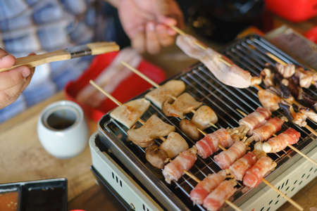 Barbecue cooking or Mala with pork, ham and mushroom on portable stoveの写真素材