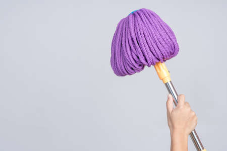 Hand holding fiber modern floor mop with twist drying function on white backgroundの写真素材