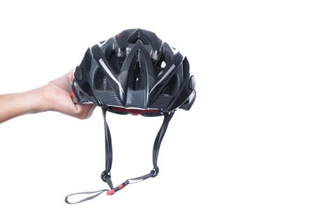 Hand holding bicycle safety helmet for mountain bike or all purpose rider on white backgroundの写真素材