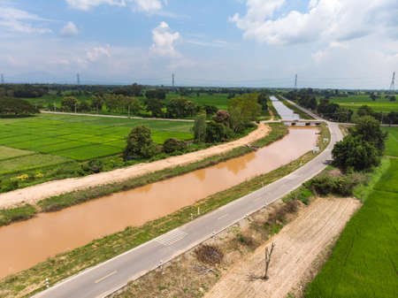 Water canal next to rice field in Asian countryのeditorial素材