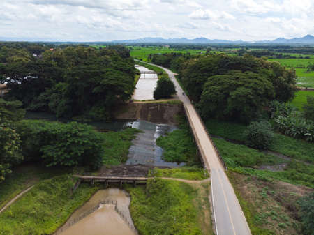 Water canal intersection with two levels next to rice field in Asian countryのeditorial素材