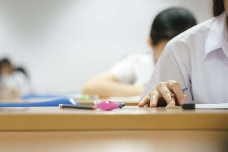 Asian university students taking an exam in class roomの写真素材
