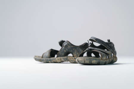 Dirty feet with sandal shoes full of dirt from trekking or off road walkの写真素材