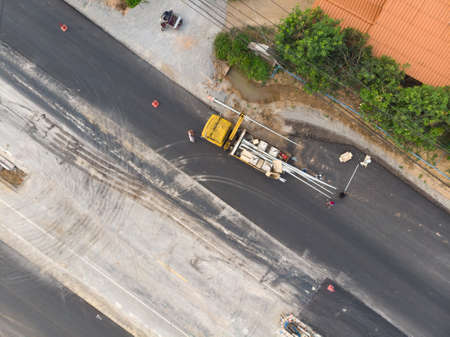 Street light or road lamp setup by worker at construction road in Asian country