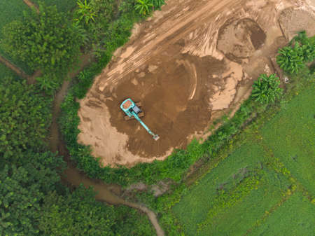 Backhoe excavator operator job by digging soil and sandの写真素材