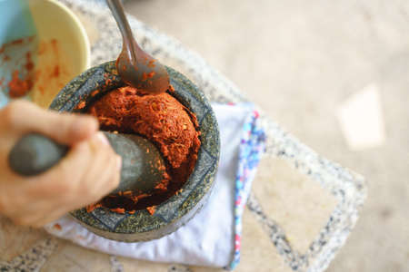 Thai chili traditional food cooking style by grinding in stone mortar with pestleの写真素材
