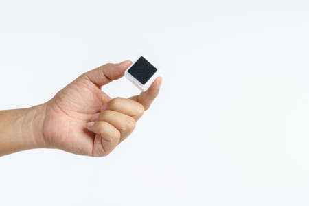 Hand holding ink stamp pad box on white backgroundの写真素材