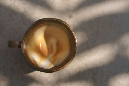 Cup of coffee with latte art pattern milk foamの写真素材