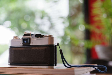 Old and vintage or old film photo camera on the bookの写真素材